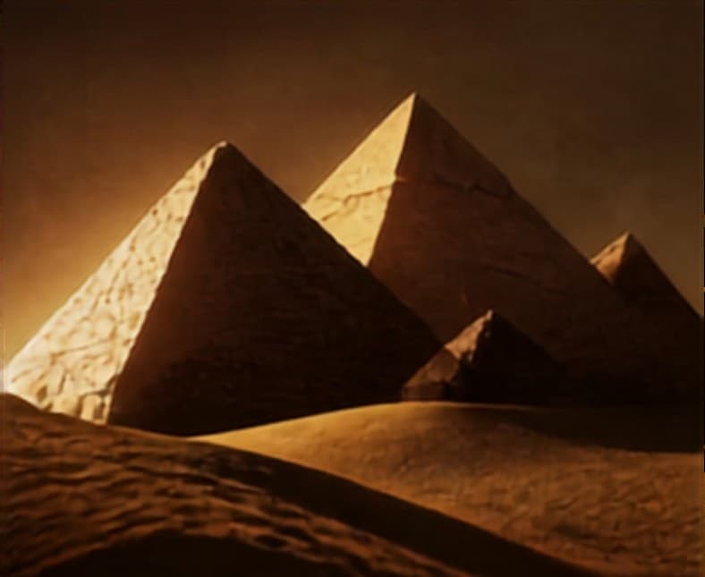 The pyramids of Giza in warm, low light